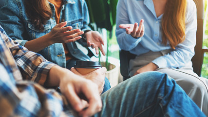 A group of young people sitting and talking together