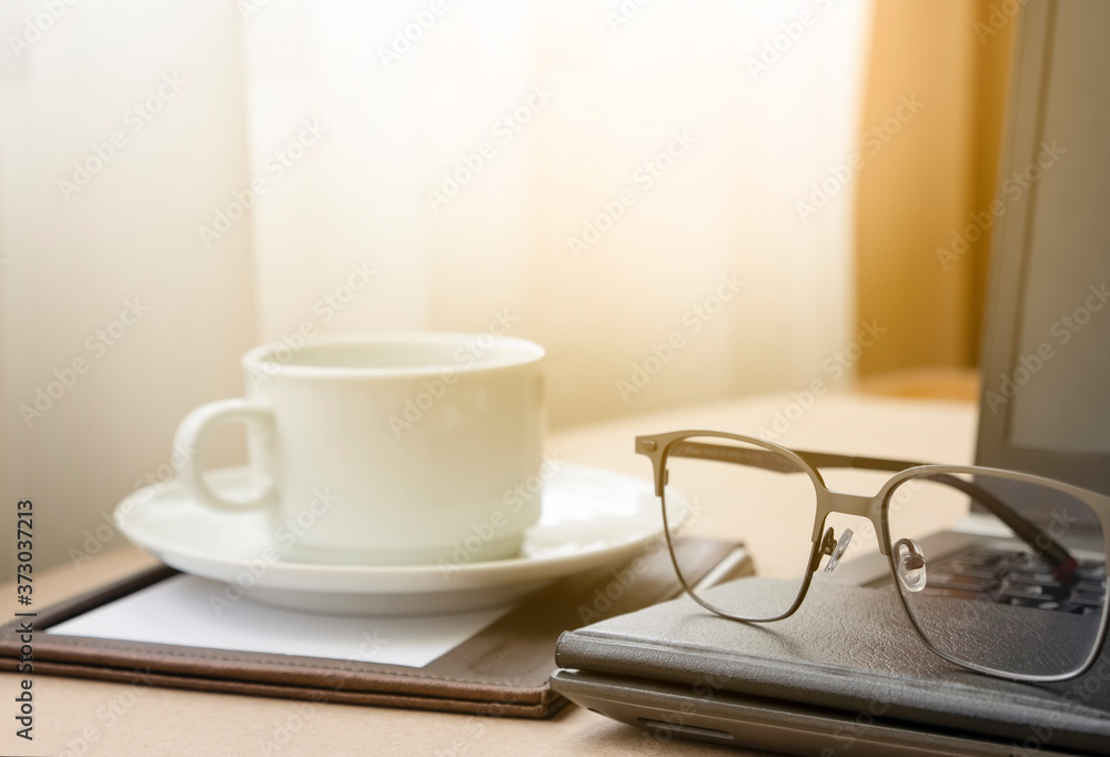 Working from home with laptop glasses pen and coffee cup hot in the morning. Workspace background composition with space for text. Enjoy love relax time during working at home with copy space. Working from home with laptop glasses pen and coffee cup hot in the morning. Workspace background composition with space for text. Enjoy love relax time during working at home with copy space.