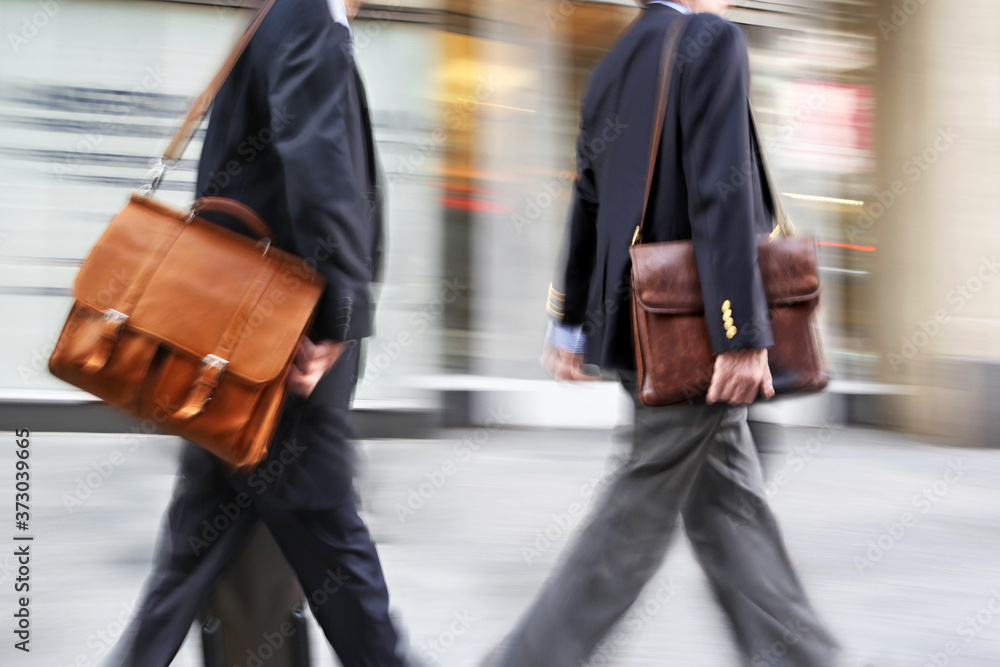 Fototapeta premium motion blurred business people walking on the street