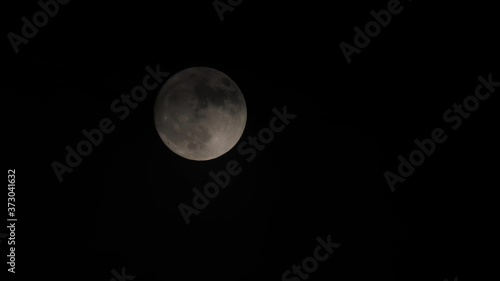 creepy cloud moving in full moon photo