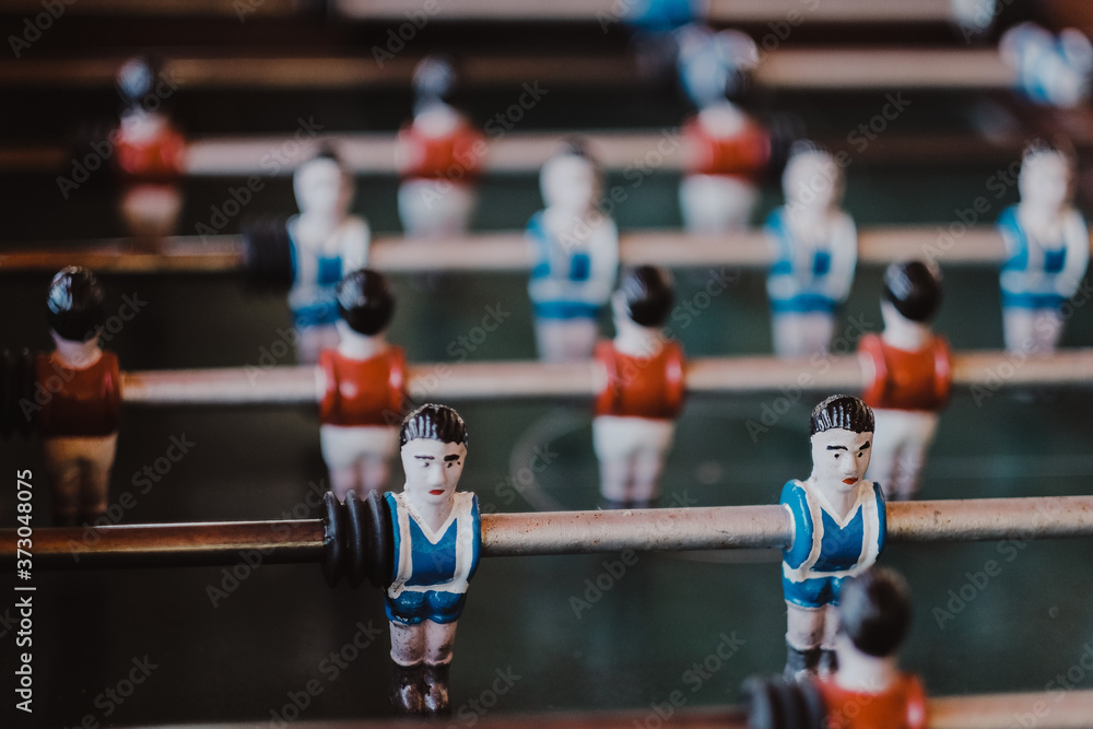 Selective shot of an aged foosball football player figures - obrazy, fototapety, plakaty 