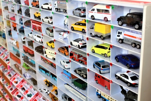 Diecast model cars are displayed for sale on a shelf in a toy store photo