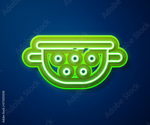 Glowing neon line Kitchen colander icon isolated on blue background. Cooking utensil. Cutlery sign. Vector.