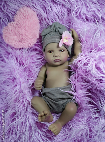 Photography The little ethnic reborn doll girl in pink