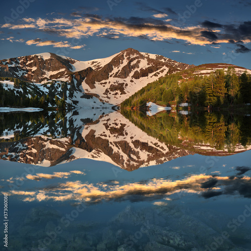 Beautiful reflection of mountains and sky in the lake, Altai. Sunset light.