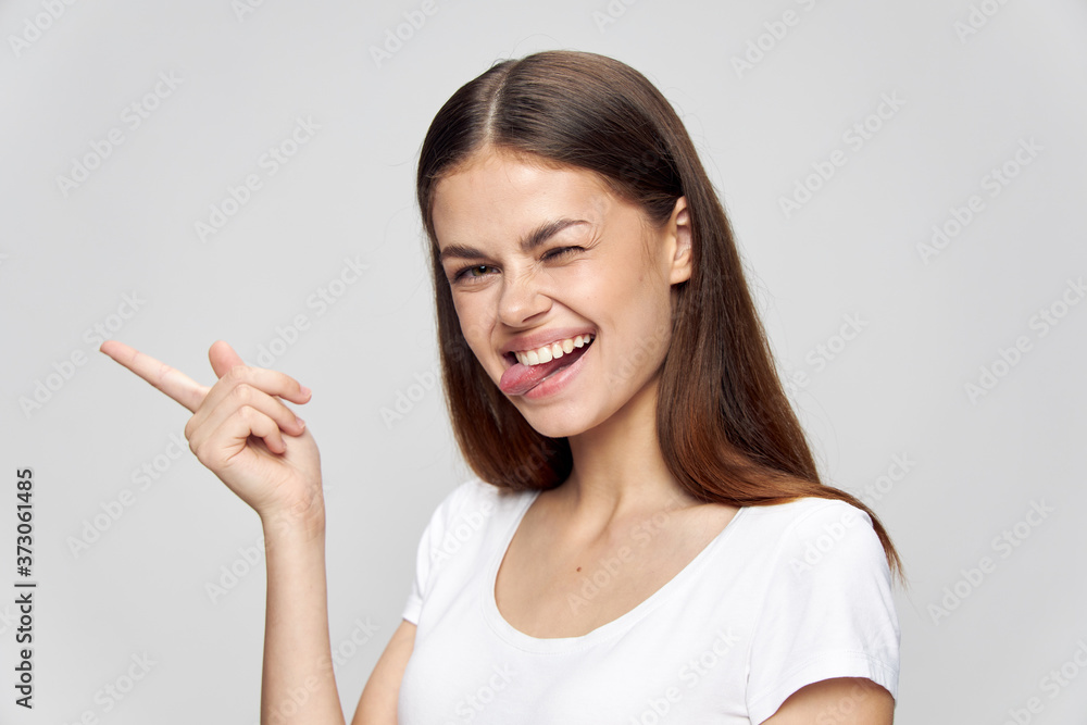 Woman showing tongue and finger to the side over fun laugh Copy Space Woman showing tongue and finger to the side over fun laugh Copy Space