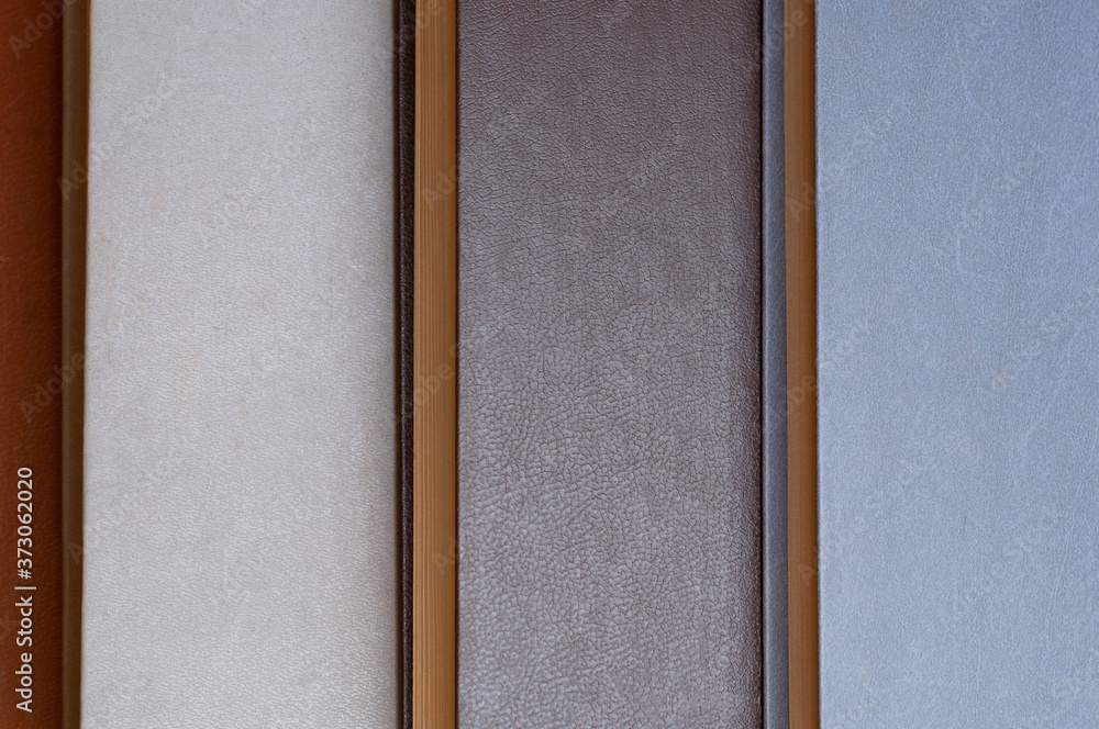 Fototapeta premium Old Books Background. Top view of retro book covers in beige, gray and blue colours