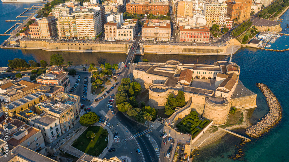 Beautiful panoramic aerial view photo from flying drone on Old medieval Aragonese Castle on sea channel, old town of Taranto city, Puglia (Apulia), Italy (Series)
