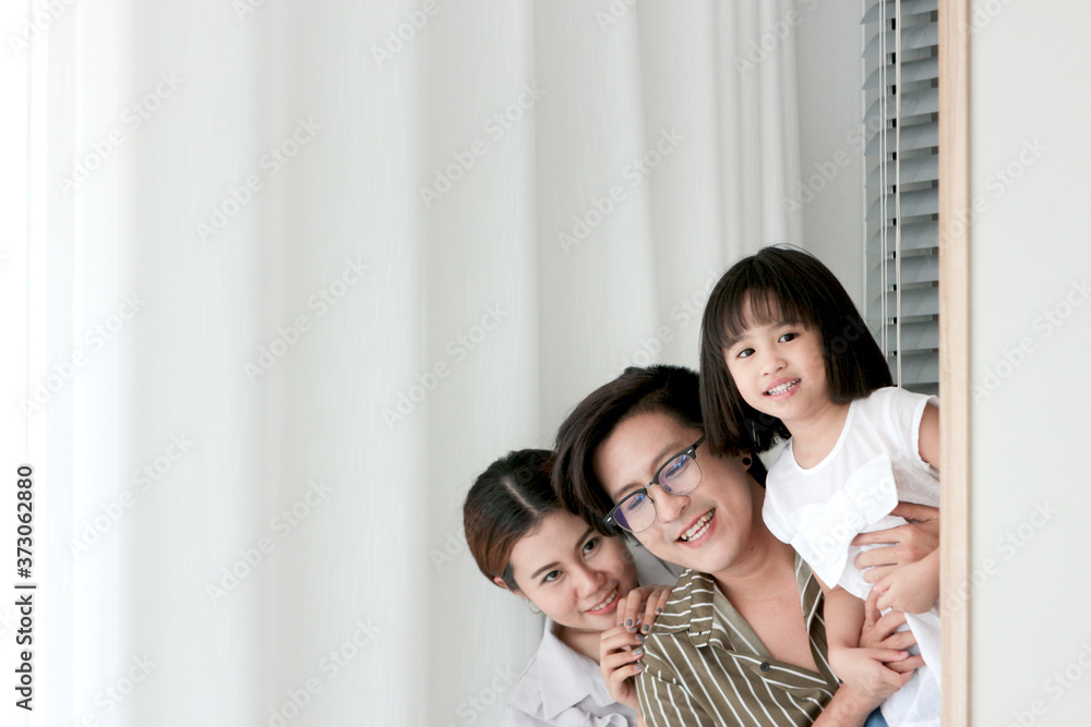 Happy family having fun in the bedroom. Father, mother, and daughter spending time together, playing hide and seek, parents and kid having good memory together at home Happy family having fun in the bedroom. Father, mother, and daughter spending time together, playing hide and seek, parents and kid having good memory together at home