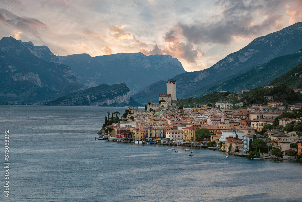 Beautiful sunset over old town of Malcesine, Lake Garda, popular travel destination in Italy, Castello Scaligero, medieval town
