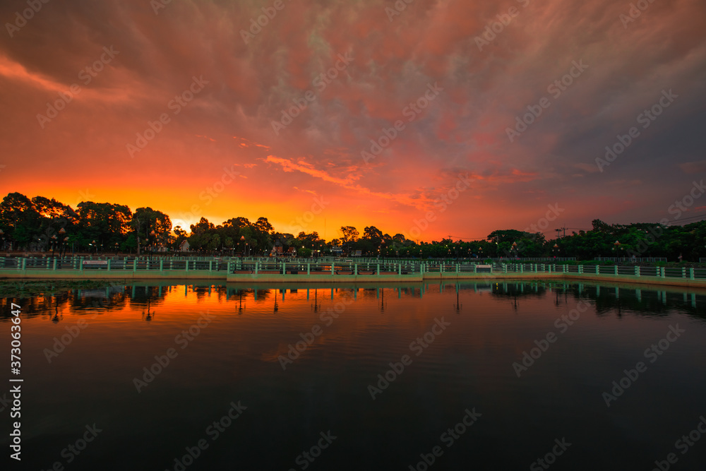 The blurry abstract background of the morning sky by the reservoir and there is a walkway to watch nature for exercise or rest while traveling. The blurry abstract background of the morning sky by the reservoir and there is a walkway to watch nature for exercise or rest while traveling.