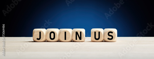 Join us concept on wooden cubes against blue background. Job vacancy or community membership announcement concept. photo