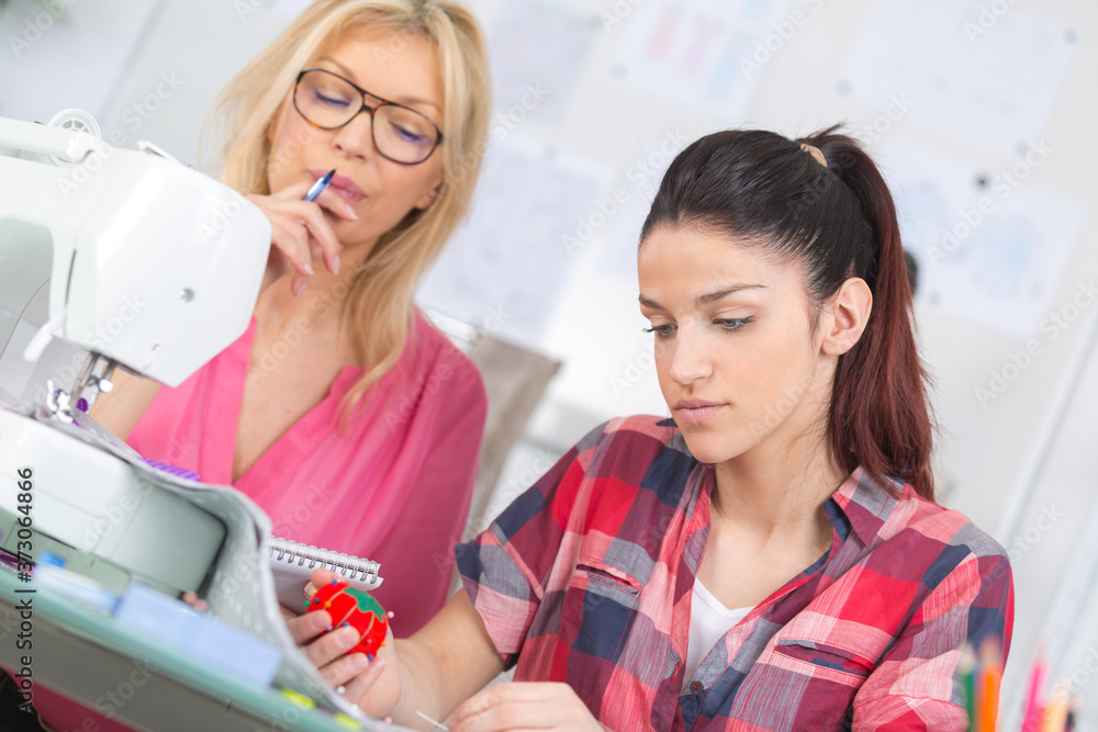 Fototapeta premium student with teacher in dressmaking class