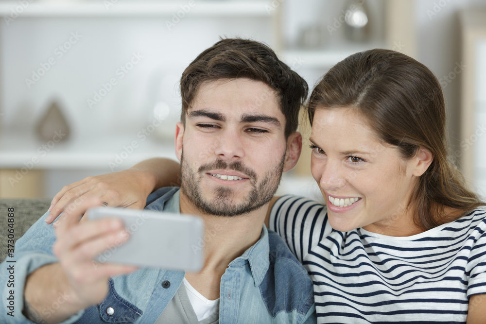 couple photographing themselves by cell phone couple photographing themselves by cell phone