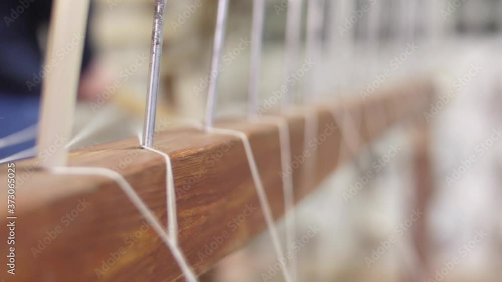 making traditional tapestry on a wooden weaving loom making traditional tapestry on a wooden weaving loom