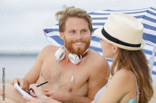happy couple having a romantic chat near the sea