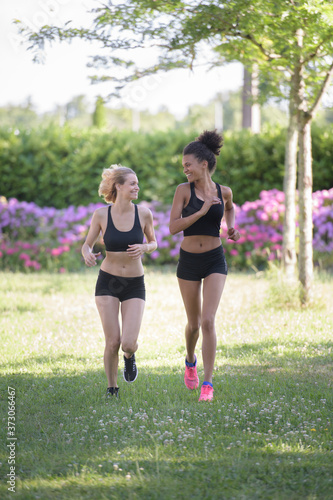portrait of female friends jogging