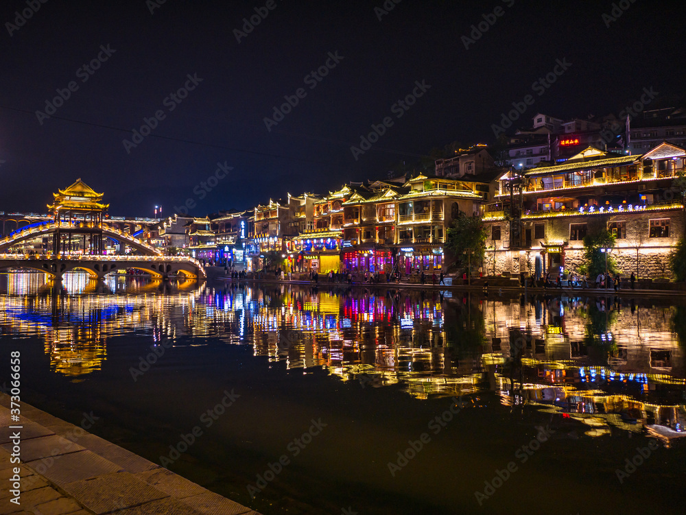 Fototapeta premium fenghuang,Hunan/China-16 October 2018:Tourist walking with beautiful Scenery view in the night of fenghuang old town .phoenix ancient town or Fenghuang County is a county of Hunan Province, China