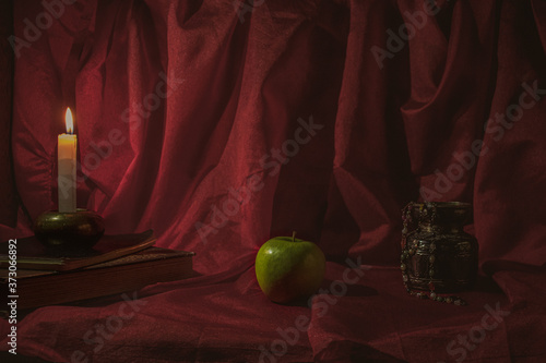 Still life with apple and candle