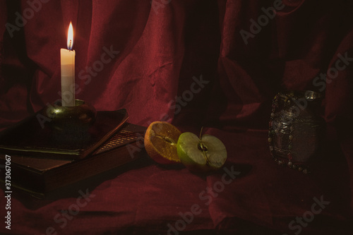 Still life with candles and fruits