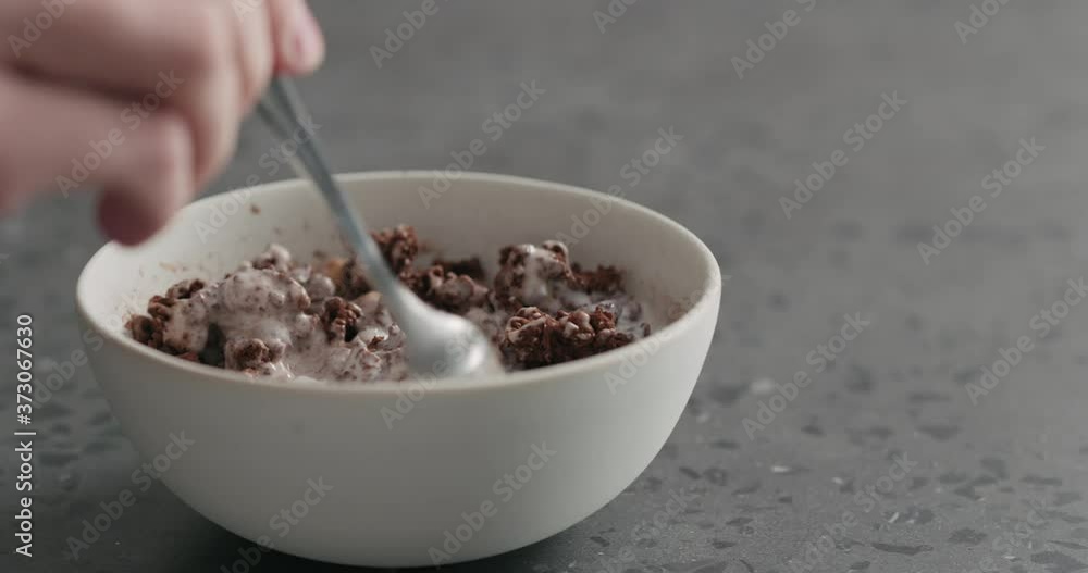 Slow motion man hand eat chocolate granola with yogurt Slow motion man hand eat chocolate granola with yogurt