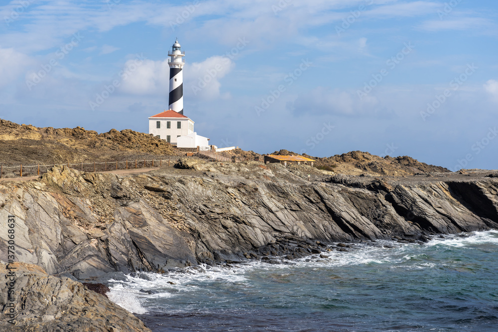 East coast with a lighthouse on the island of Menorca. Balearic Islands, Spain