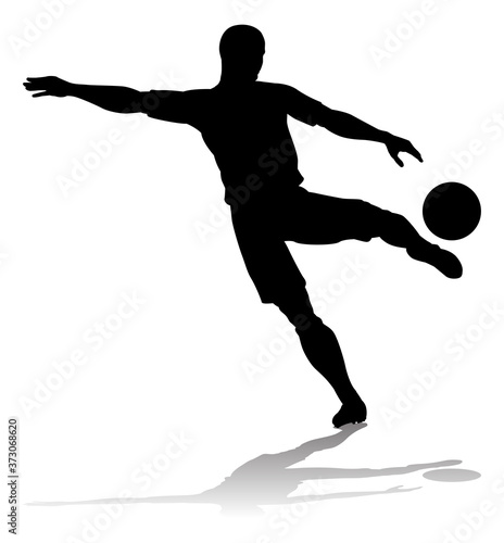 A soccer or football player in silhouette