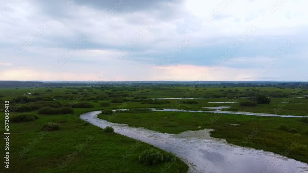 Drone flight over a winding shallow river. Drone flight over a winding shallow river.