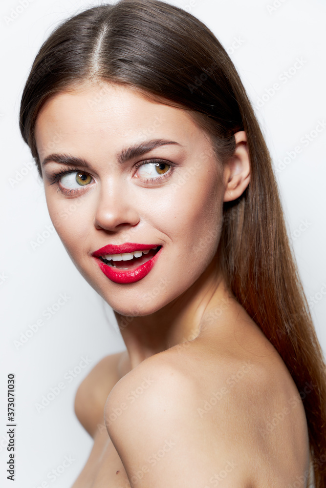 Charming woman Naked shoulders look towards red lips smile clear skin Charming woman Naked shoulders look towards red lips smile clear skin