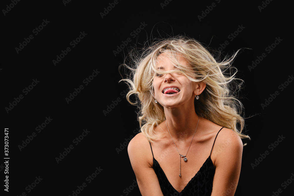 Low key photo of young happy woman with flowing hair Low key photo of young happy woman with flowing hair