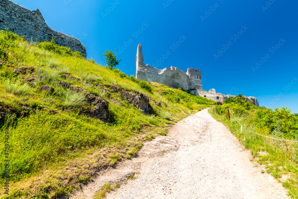 The old ruins of castle Cachtice (Čachtice in local speak). Ruined castle on top of hill at Slovakia. Famous and mysterious place known from legend of blood lady Bathory. Summer day, panorama view.