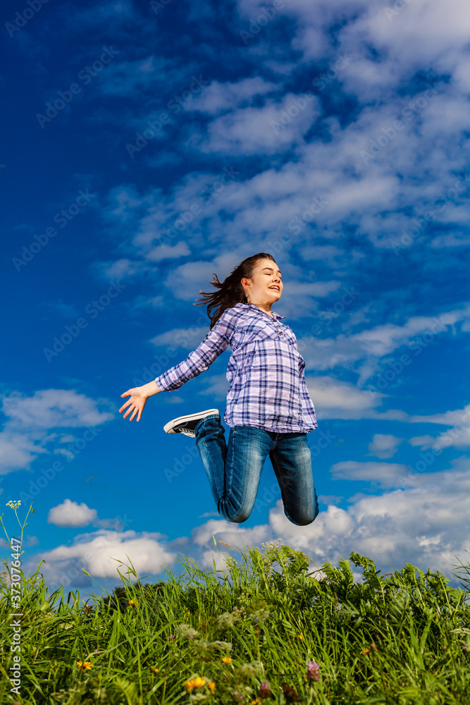 Girl jumping, running against blue sky
Girl jumping, running against blue sky