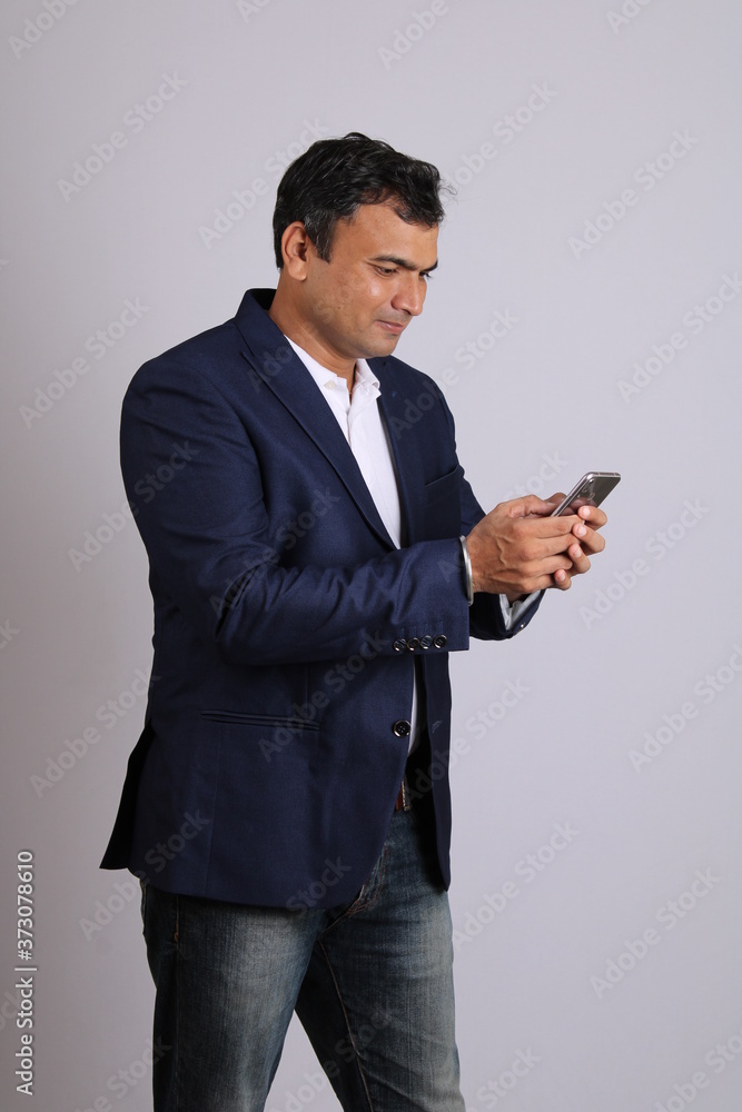 Young confidant Indian business man using cell phone. isolated on white background. Young confidant Indian business man using cell phone. isolated on white background.