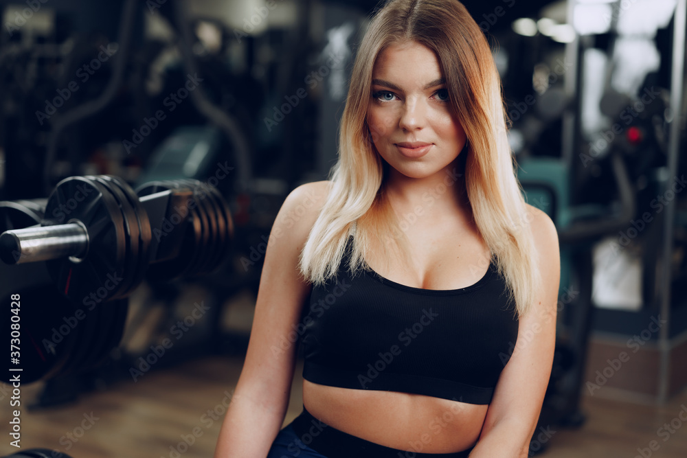 Portrait of a fit young blonde woman in black sport bra