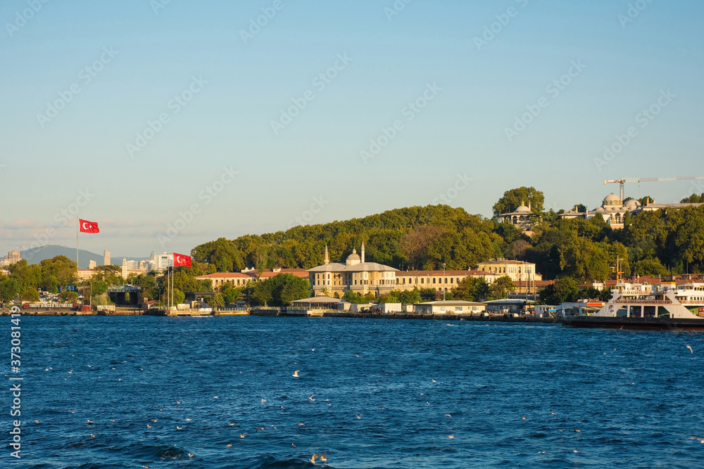 The Green Crescent building on the Sultanahmet waterfront with Topkapi Palace on the hill in the background