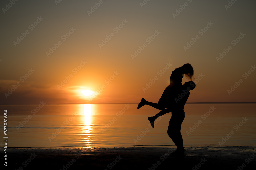 silhouette of a young woman running on the beach silhouette of a young woman running on the beach