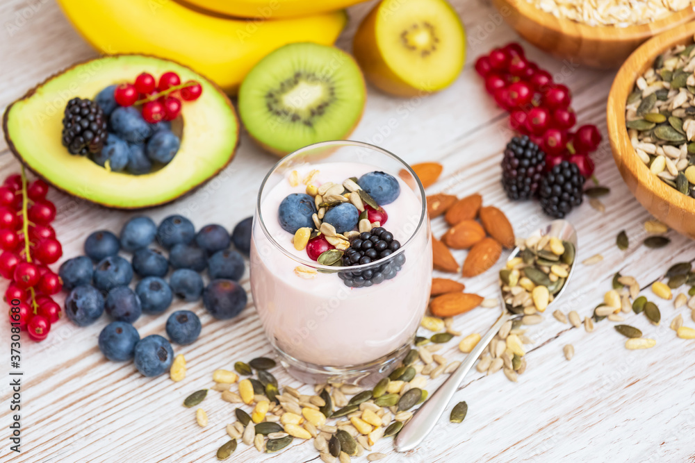 Fruits and Breakfast with Whole grains and nuts, yogurt mix with Cherry , banana, avocado in the wooden table. Breakfast for Health and Diet concept