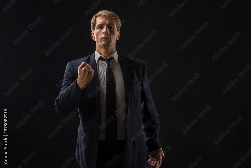 Motivational speaker, a young man in a suit and tie gives an inspirational speech. Motivational speaker, a young man in a suit and tie gives an inspirational speech.