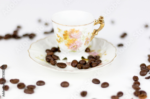 Cup of coffee or porcelain tea on white background with coffee beans
