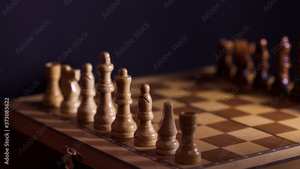 Wooden chess in a contrasting light. A game of chess, an intellectual competition, Wooden chess in a contrasting light. A game of chess, an intellectual competition,