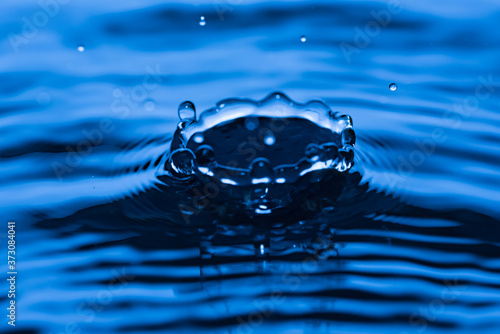 Water droplet splash on blue