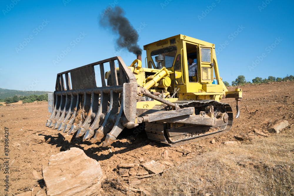 Construction Earthworks Dozer Excavator Construction industrial earthworks Bulldozer excavator. Earth-moving equipment for land clearing and foundation digging.