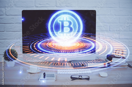 Double exposure of blockchain and crypto economy theme hologram and table with computer background. Concept of bitcoin cryptocurrency.