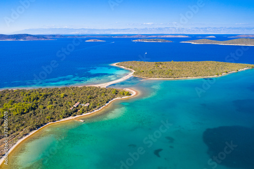 Amazing exotic islands with natural bridge in turquoise sea on the island of Dugi Otok in Croatia, drone aerial, Adriatic sea paradise