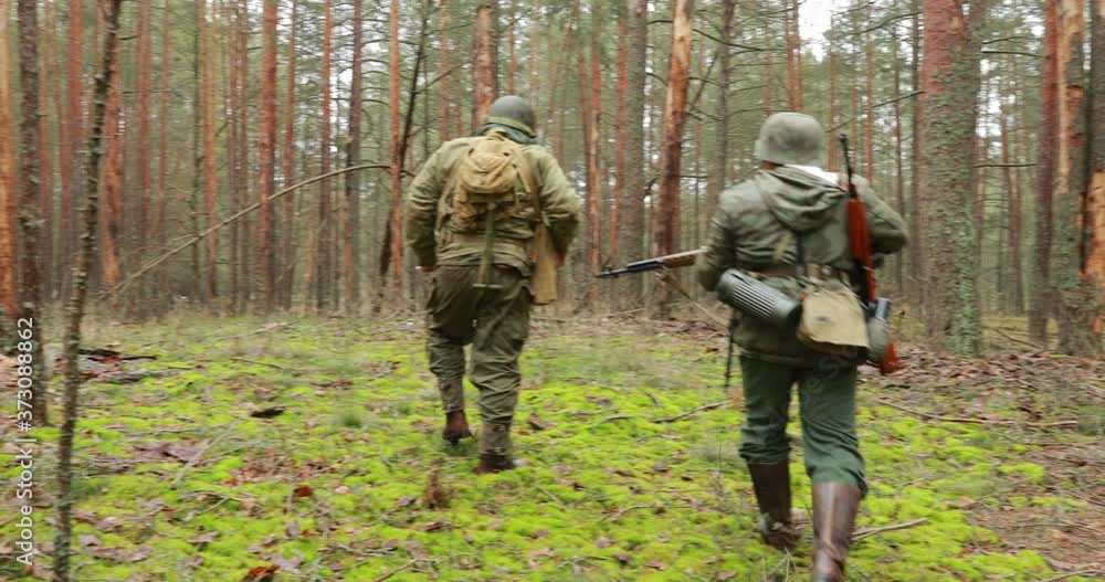 Re-enactors Dressed Like German Wehrmacht Infantry And American Soldiers Of USA Of World War II Participating In Historical Re-enactment. Wehrmacht Soldiers Surrenders American Soldiers To Captivity Re-enactors Dressed Like German Wehrmacht Infantry And American Soldiers Of USA Of World War II Participating In Historical Re-enactment. Wehrmacht Soldiers Surrenders American Soldiers To Captivity