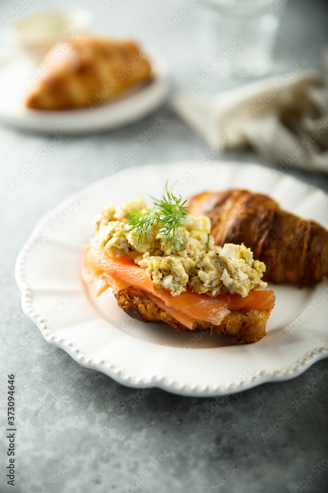 Croissant with smoked salmon and scrambled eggs Croissant with smoked salmon and scrambled eggs