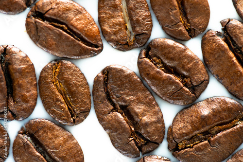 Wallpaper Mural Roasted coffee beans on white milk background. Coffee beans in milk. Top view macro shot of arabica, robusta and iberica coffee seeds.  Torontodigital.ca