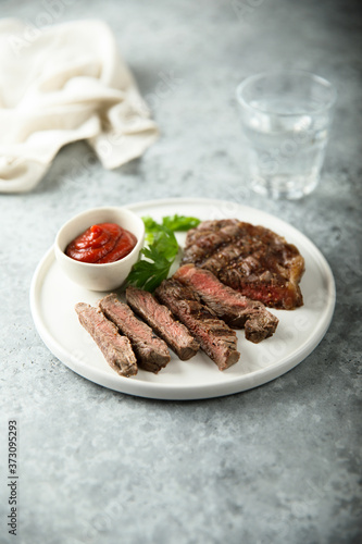 Grilled beef steak with tomato sauce