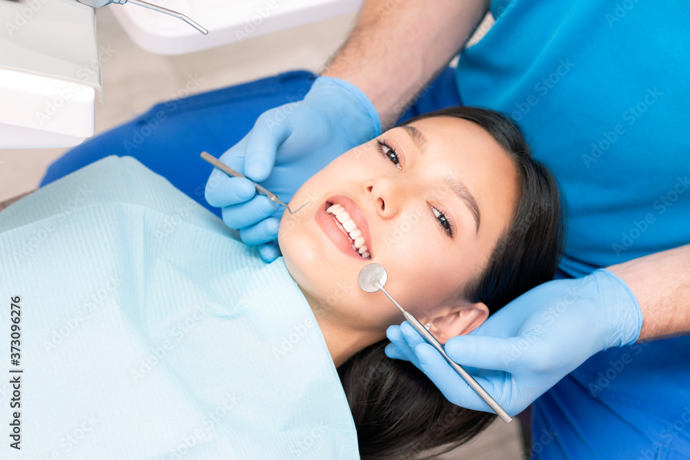 Attractive young woman in a dental clinic with a male dentist. Healthy teeth concept. Attractive young woman in a dental clinic with a male dentist. Healthy teeth concept.