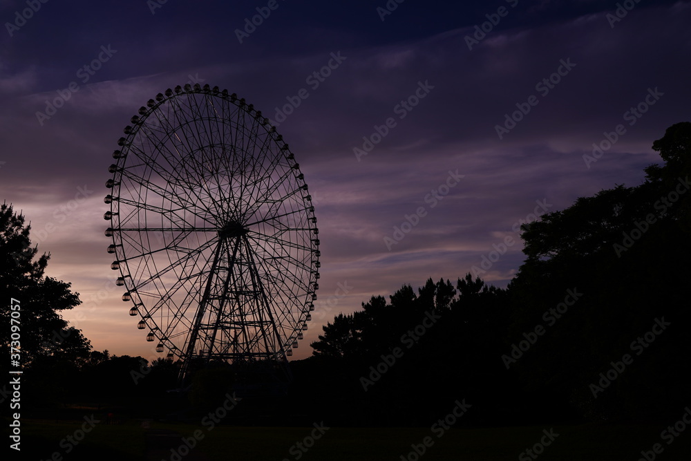 Ferris wheel after sunset at Kasai Rinkai koen, Tokyo, Japan. Purple and blue sky is beautiful. Ferris wheel after sunset at Kasai Rinkai koen, Tokyo, Japan. Purple and blue sky is beautiful.